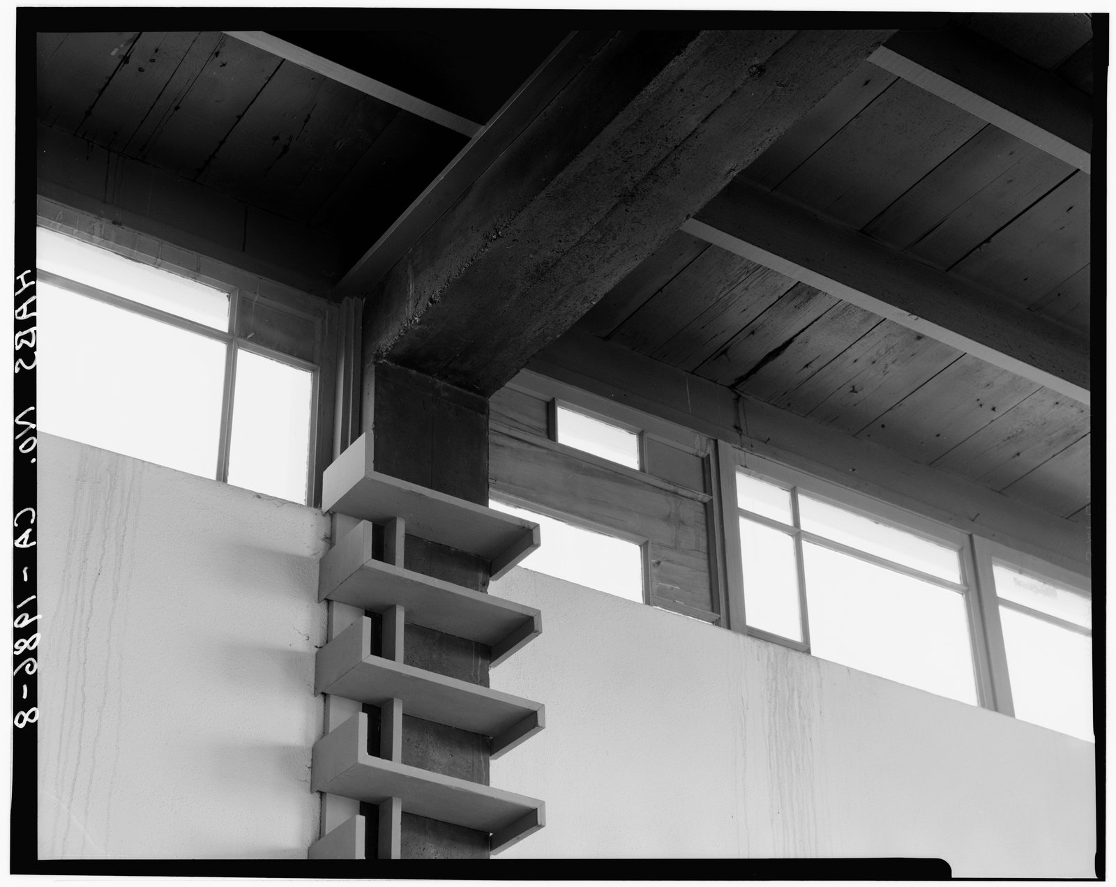 Clerestory windows running high beneath a flat roof