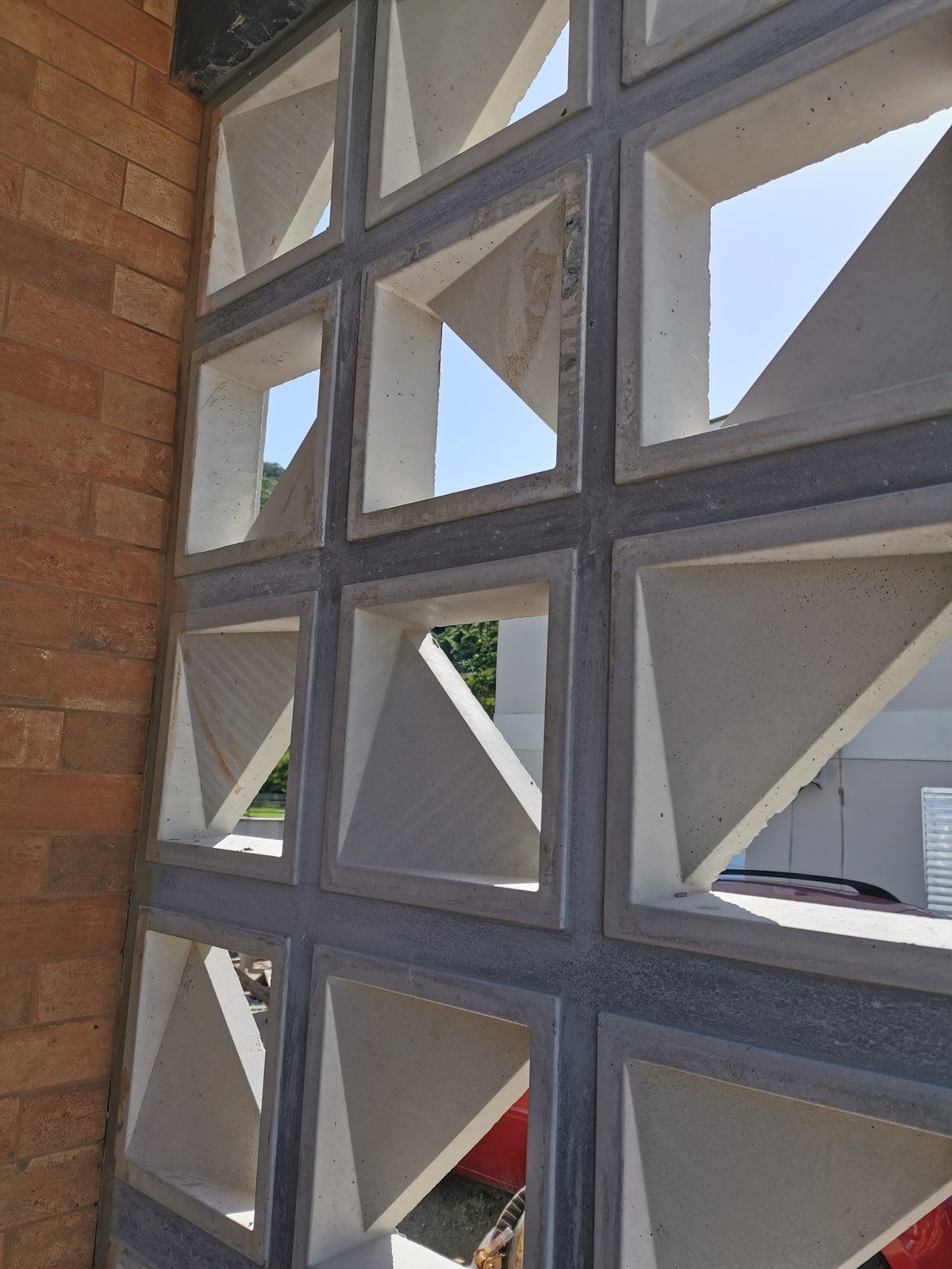 A cobogó screen of hollow ceramic blocks filtering tropical light