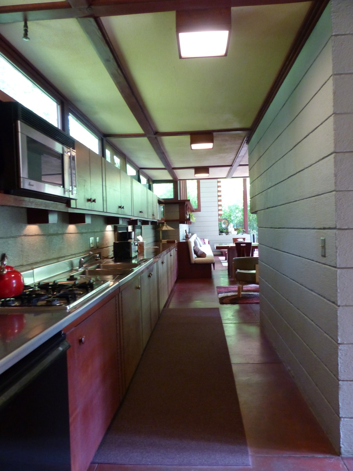 A mid-century modern kitchen with a pass-through counter and built-in cabinetry