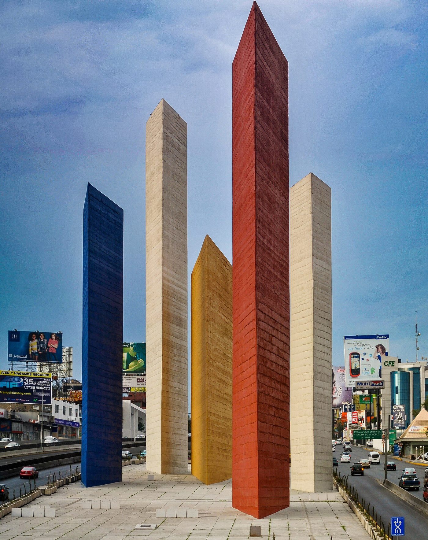 The Torres de Satélite, five tall coloured prisms rising from a Mexico City highway island