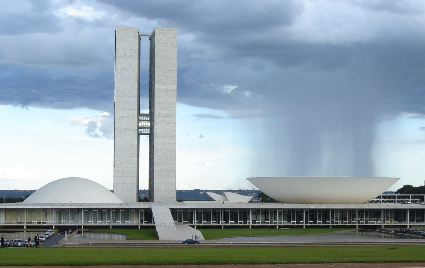 The National Congress at Brasília: twin towers, dome and bowl under a shaft of rain
