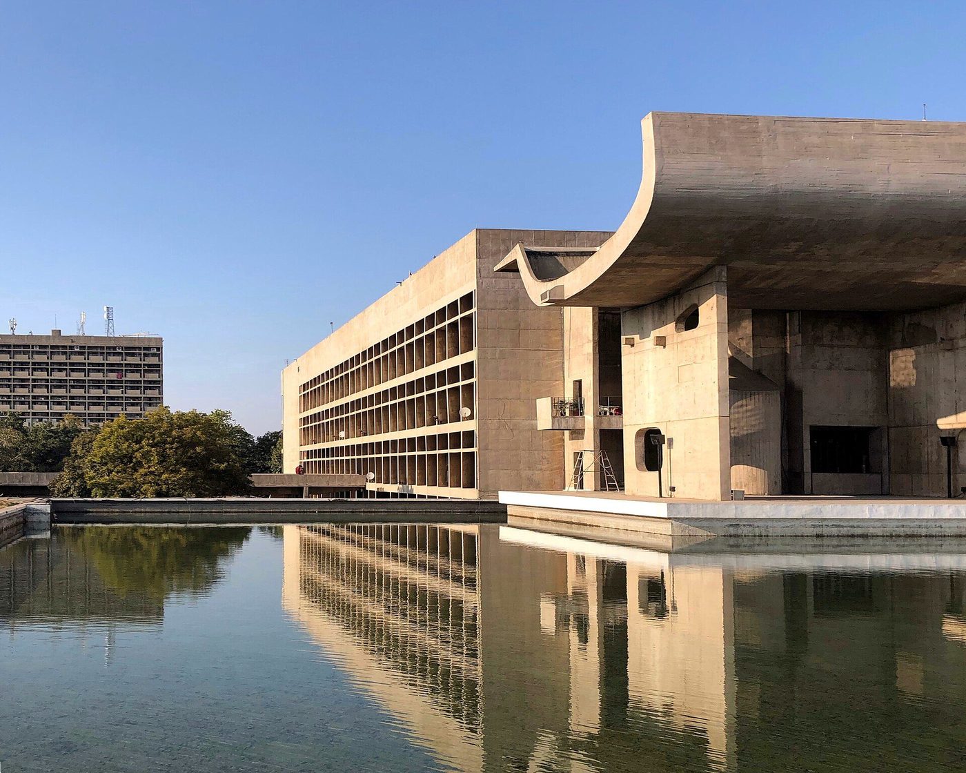 The Palace of Assembly at Chandigarh reflected in its pool, the great curved portico to the right