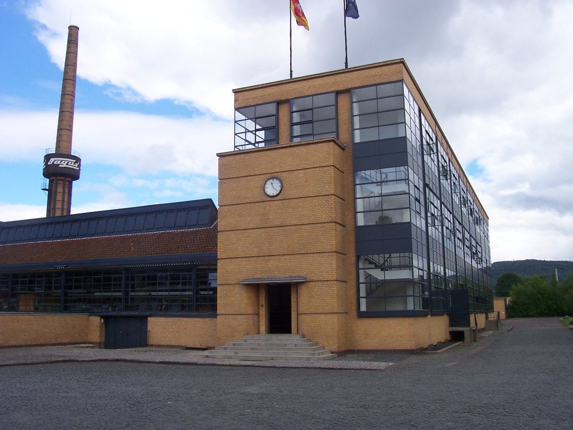 The Fagus Factory at Alfeld: brick pier block and glass curtain corner with the chimney behind