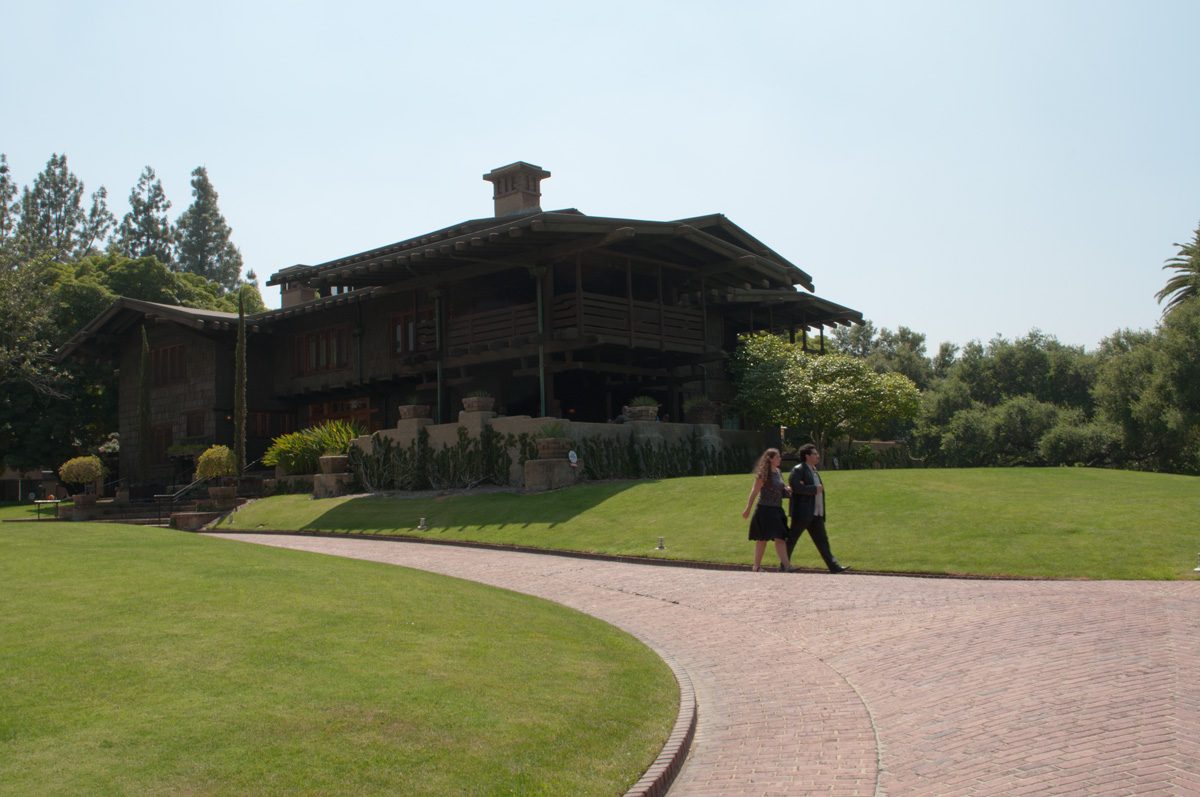 The Gamble House in Pasadena across its lawn: low timber roofs and deep porches