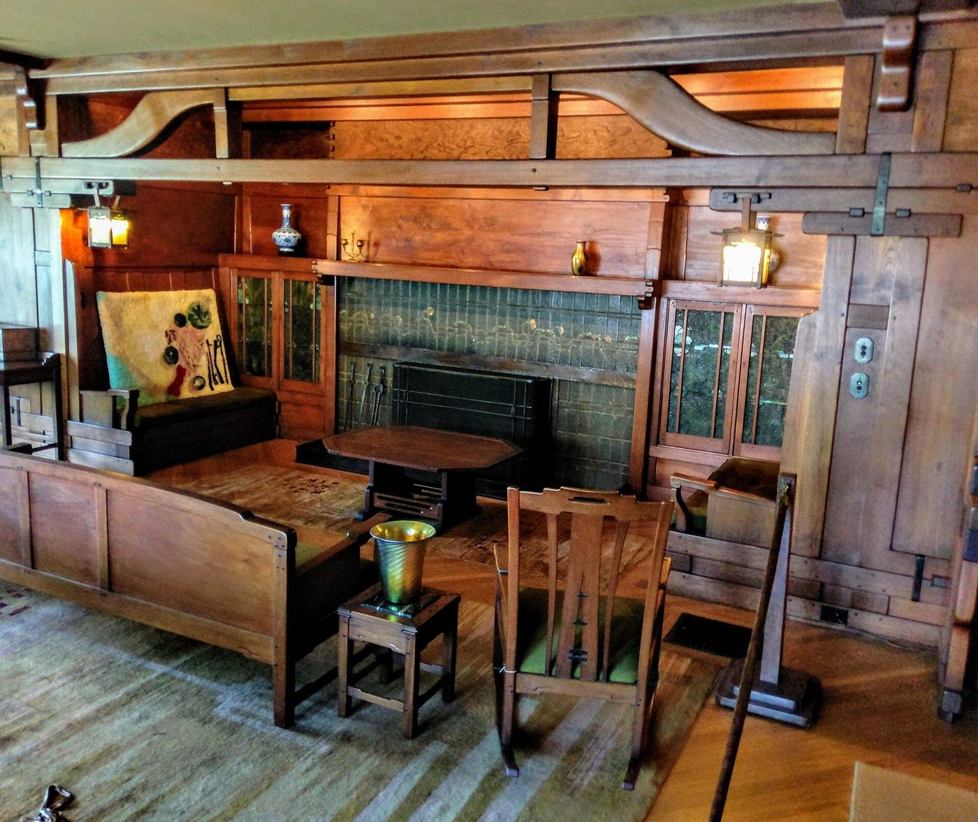 The Gamble House living room: timber trusses, tiled fireplace and built-in furniture
