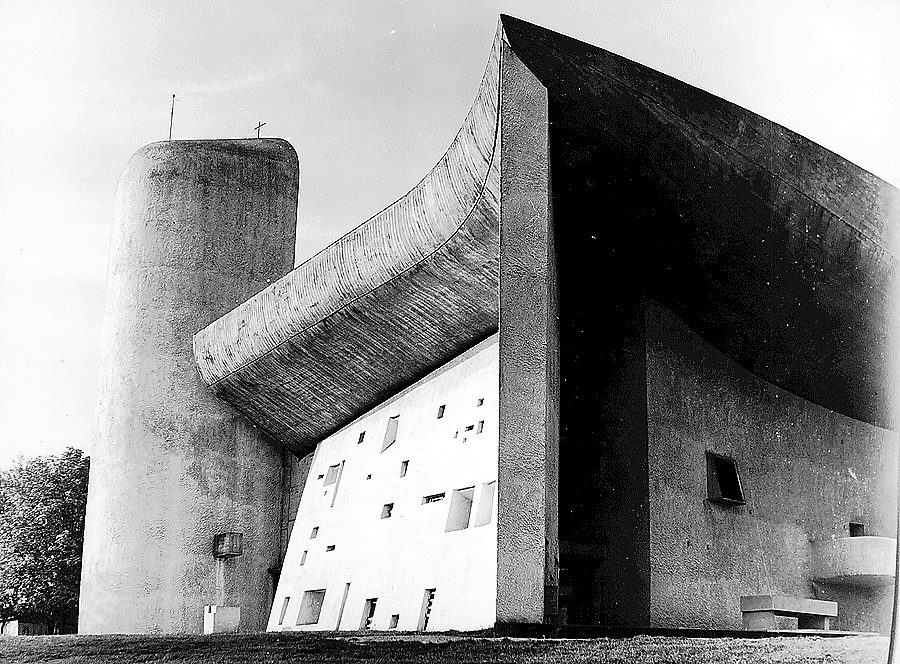 Notre Dame du Haut at Ronchamp: the great curved shell roof, south wall and tower, photographed in the 1950s
