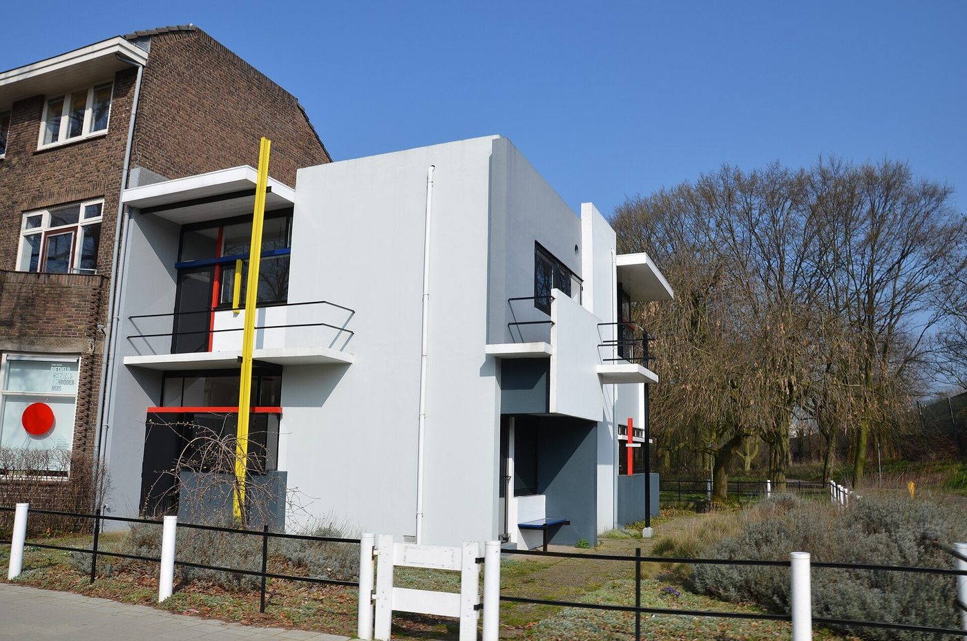 The Rietveld Schröder House at Utrecht: white and grey planes, coloured bars, at the end of a brick terrace