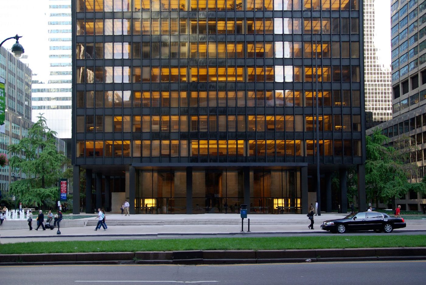 The Seagram Building in New York from across Park Avenue, its bronze and amber glass facade lit