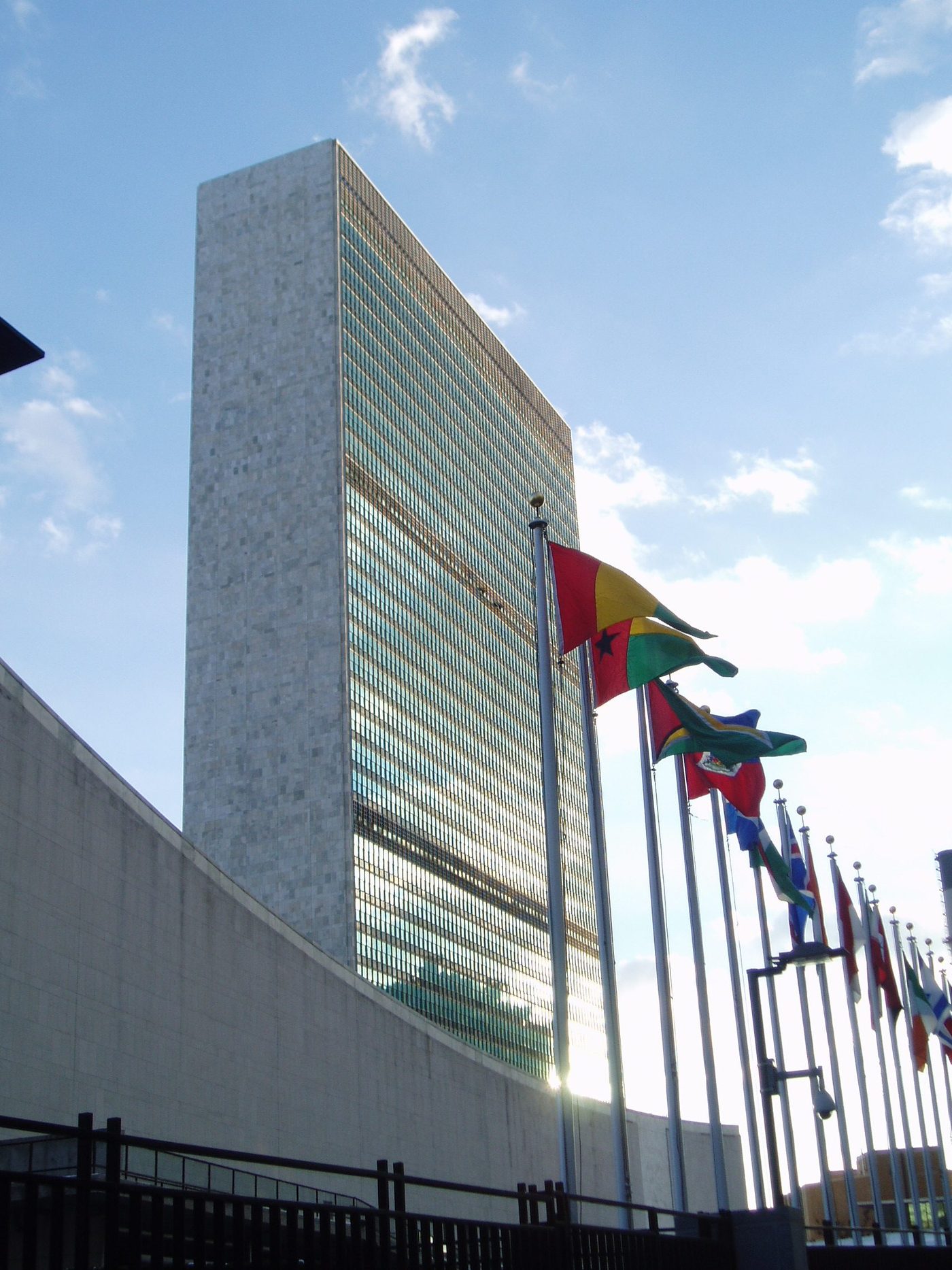 The United Nations Secretariat in New York: a glass slab behind the flags of the member states