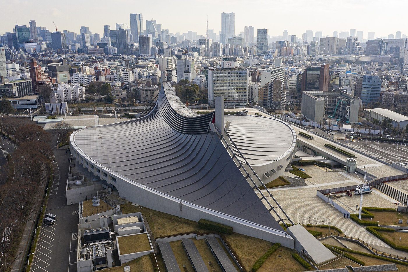 The Yoyogi National Gymnasium in Tokyo from the air: two great suspended roofs like shells above the city