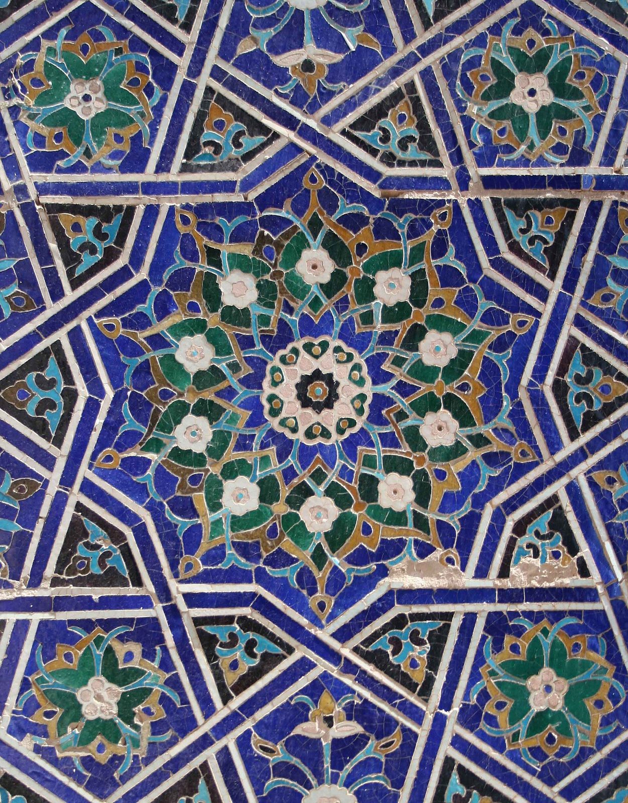 A girih star-pattern tile mosaic at Shah-i Zinda, Samarkand: interlacing stars in blue, turquoise and white