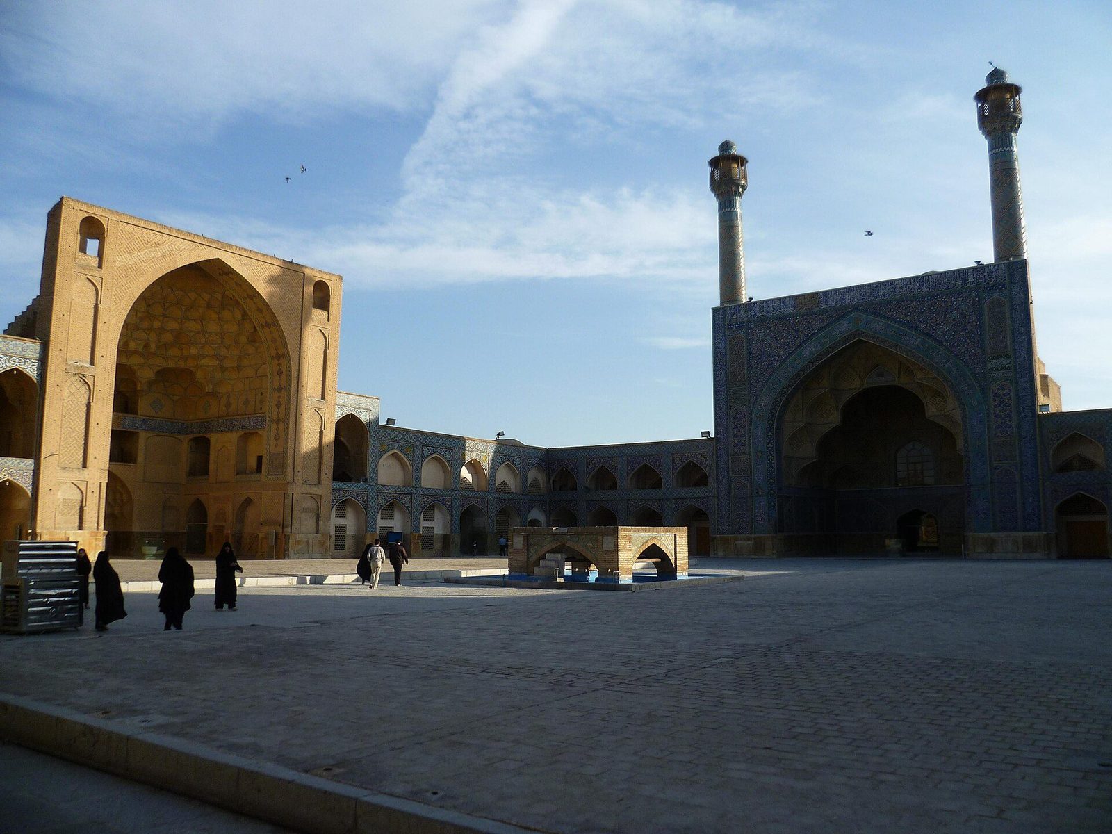 The courtyard of the Jameh Mosque of Isfahan: iwans on four sides and the twin minarets of the south iwan