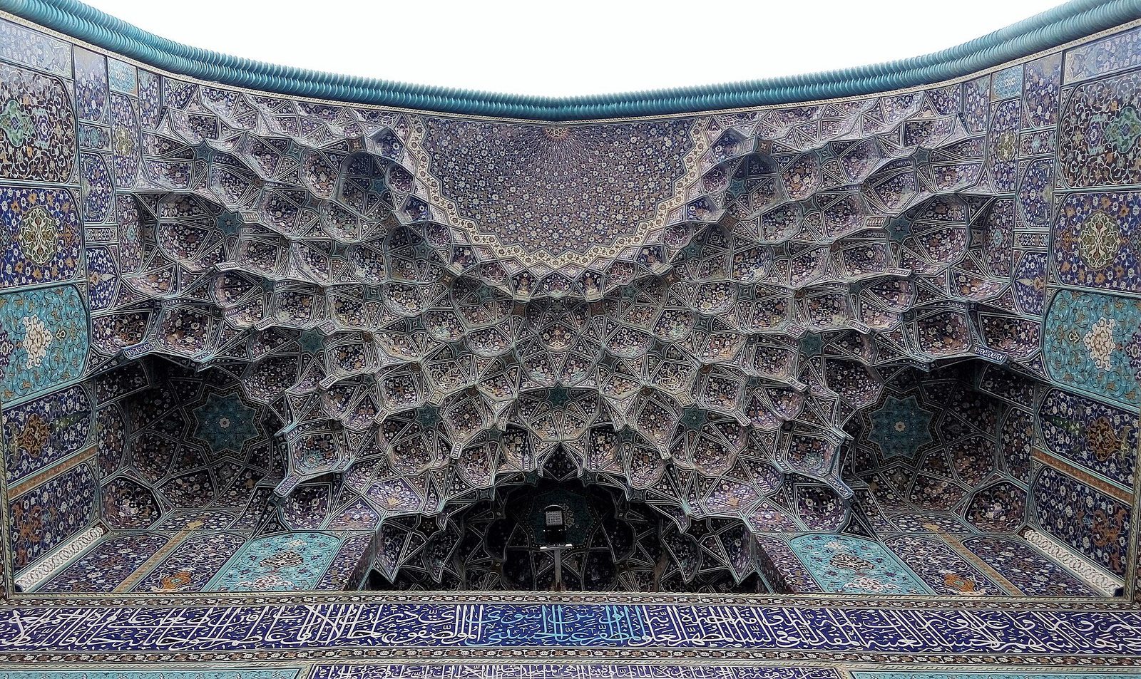 The muqarnas semi-dome of the Shah Mosque portal in Isfahan, its tiers of cells revetted in blue tile mosaic