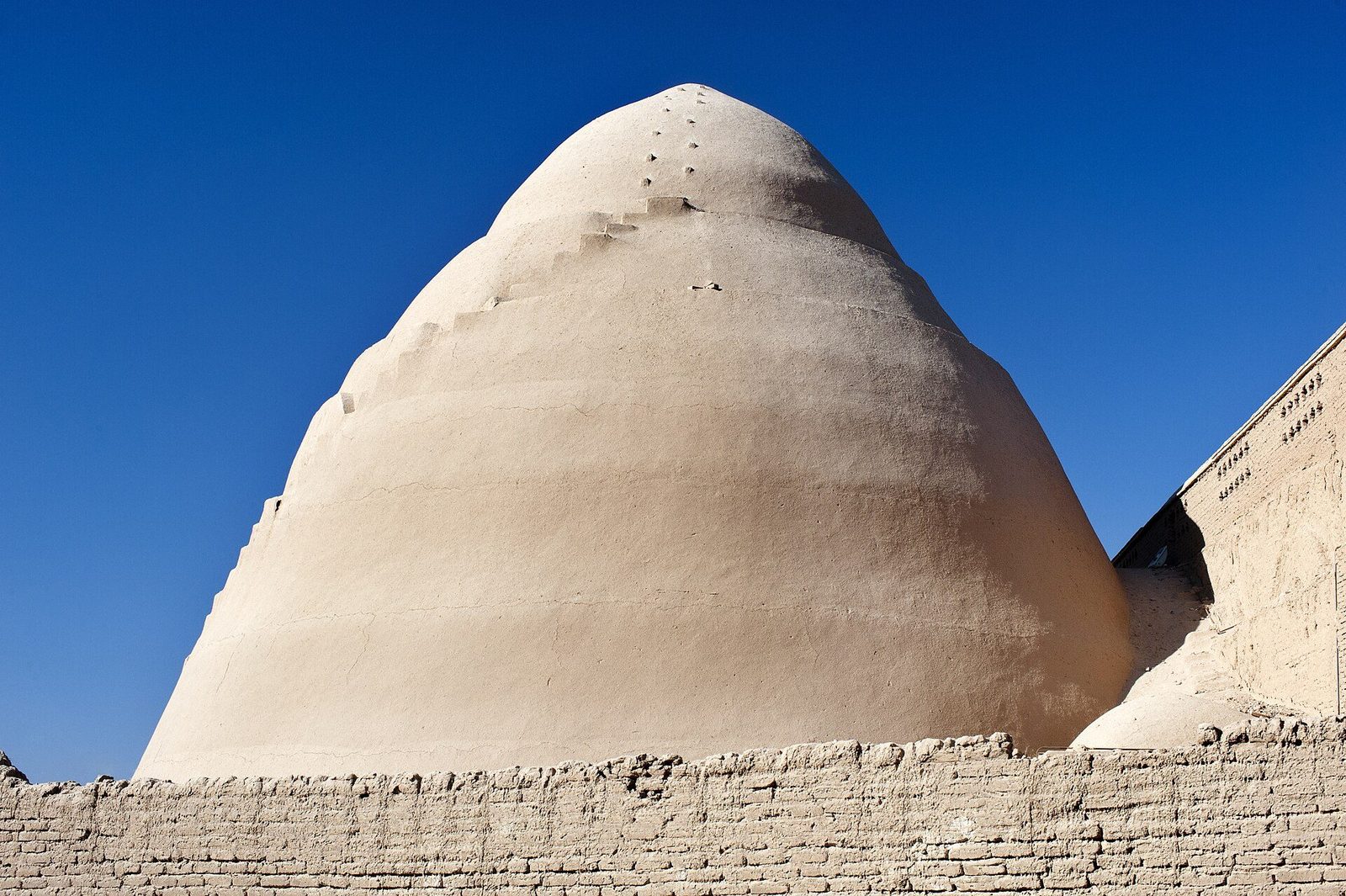 The yakhchal at Meybod: the great conical adobe dome of the ice house against the sky