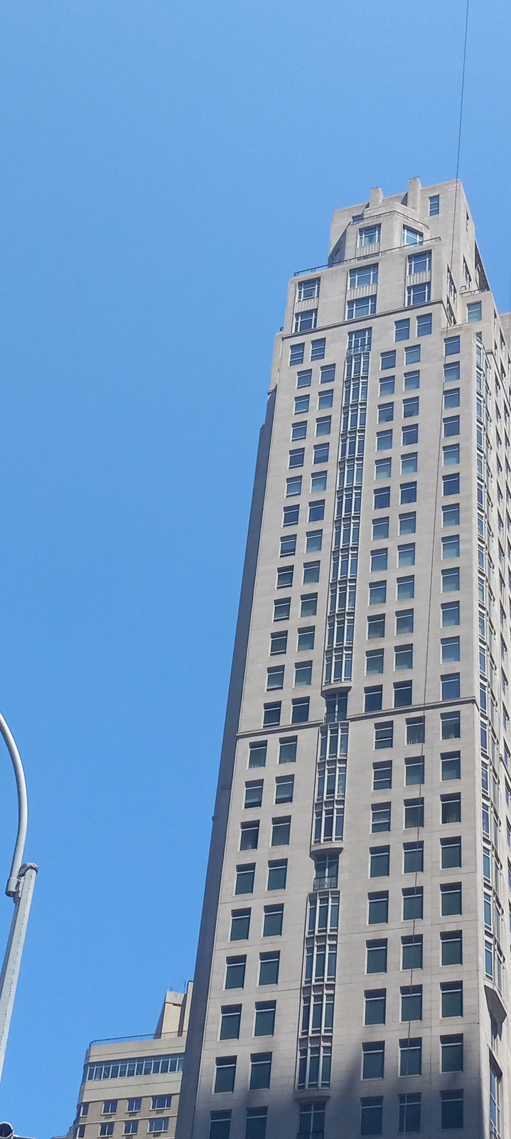 15 Central Park West in New York, a tall limestone apartment tower with a stepped crown, seen from street level.