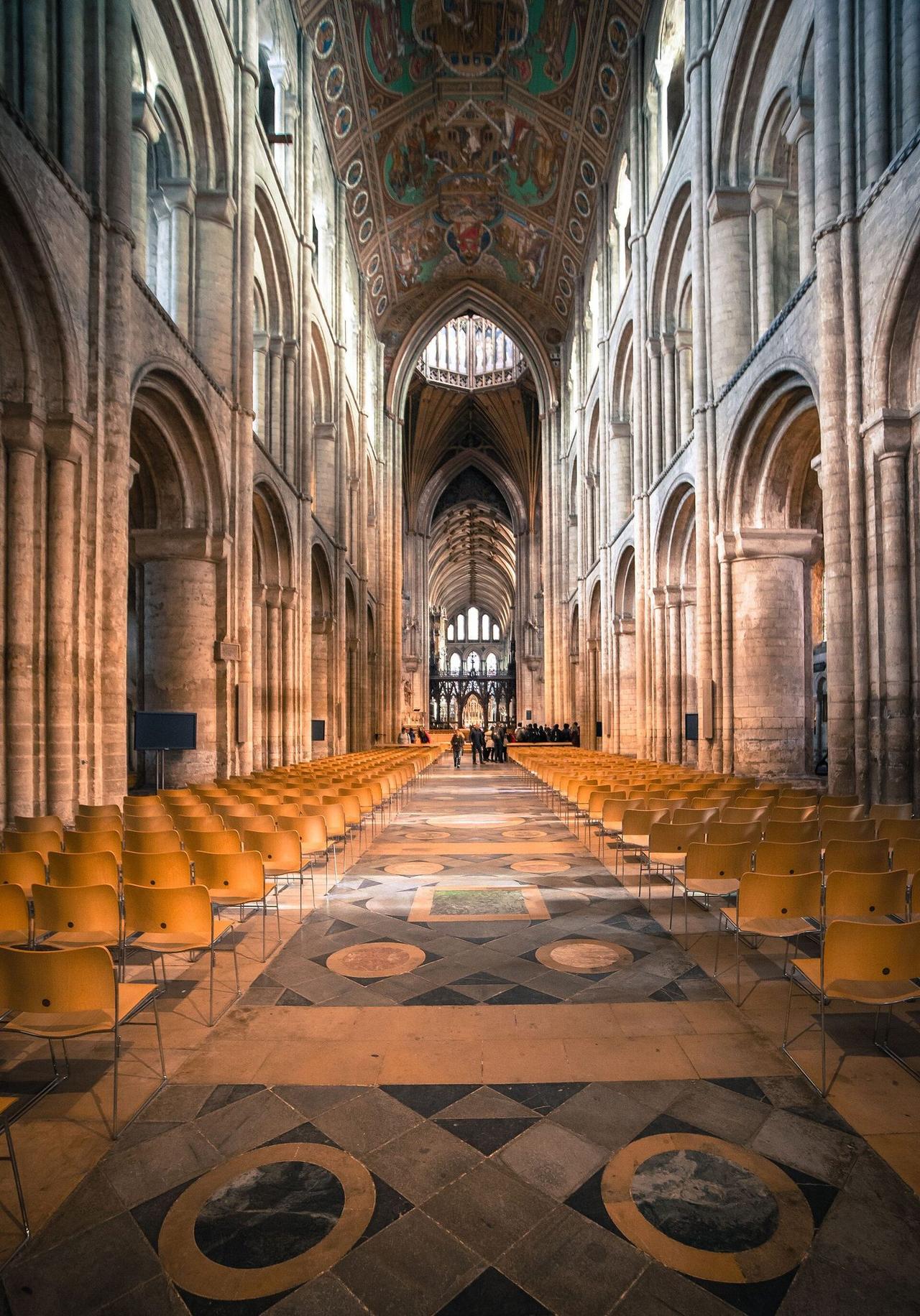 The nave of Ely Cathedral looking east under its painted ceiling