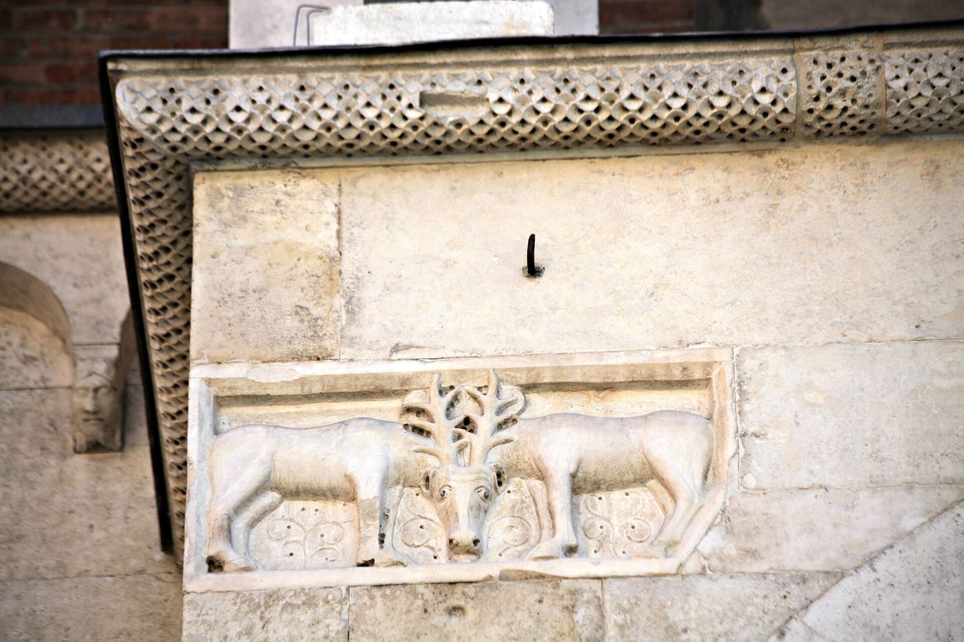 A facade metope of Modena Cathedral: two stags at the tree of life