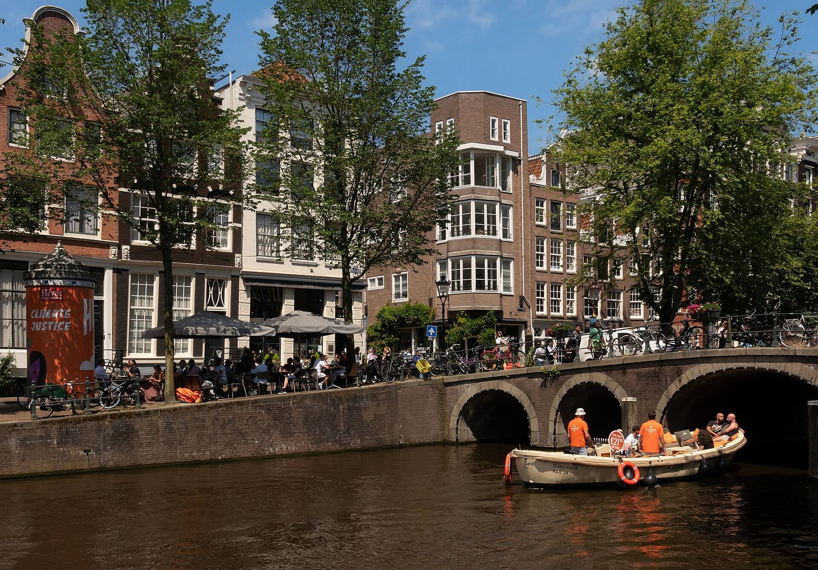 Canal houses along the Herengracht in Amsterdam, with a bridge and a boat