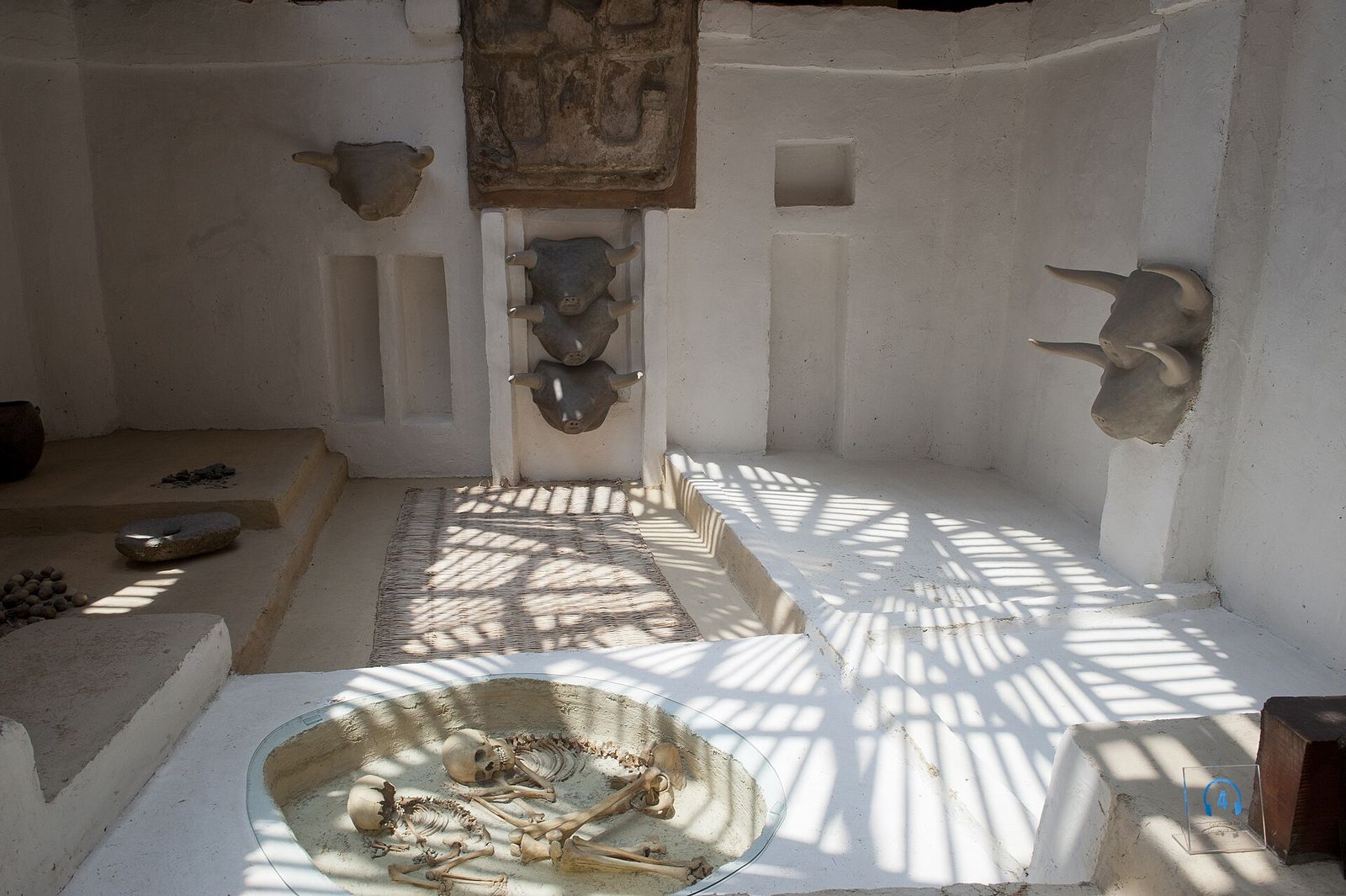 A reconstructed Çatalhöyük room in the Museum of Anatolian Civilizations, Ankara: raised platforms, a hearth and bull heads set into the wall