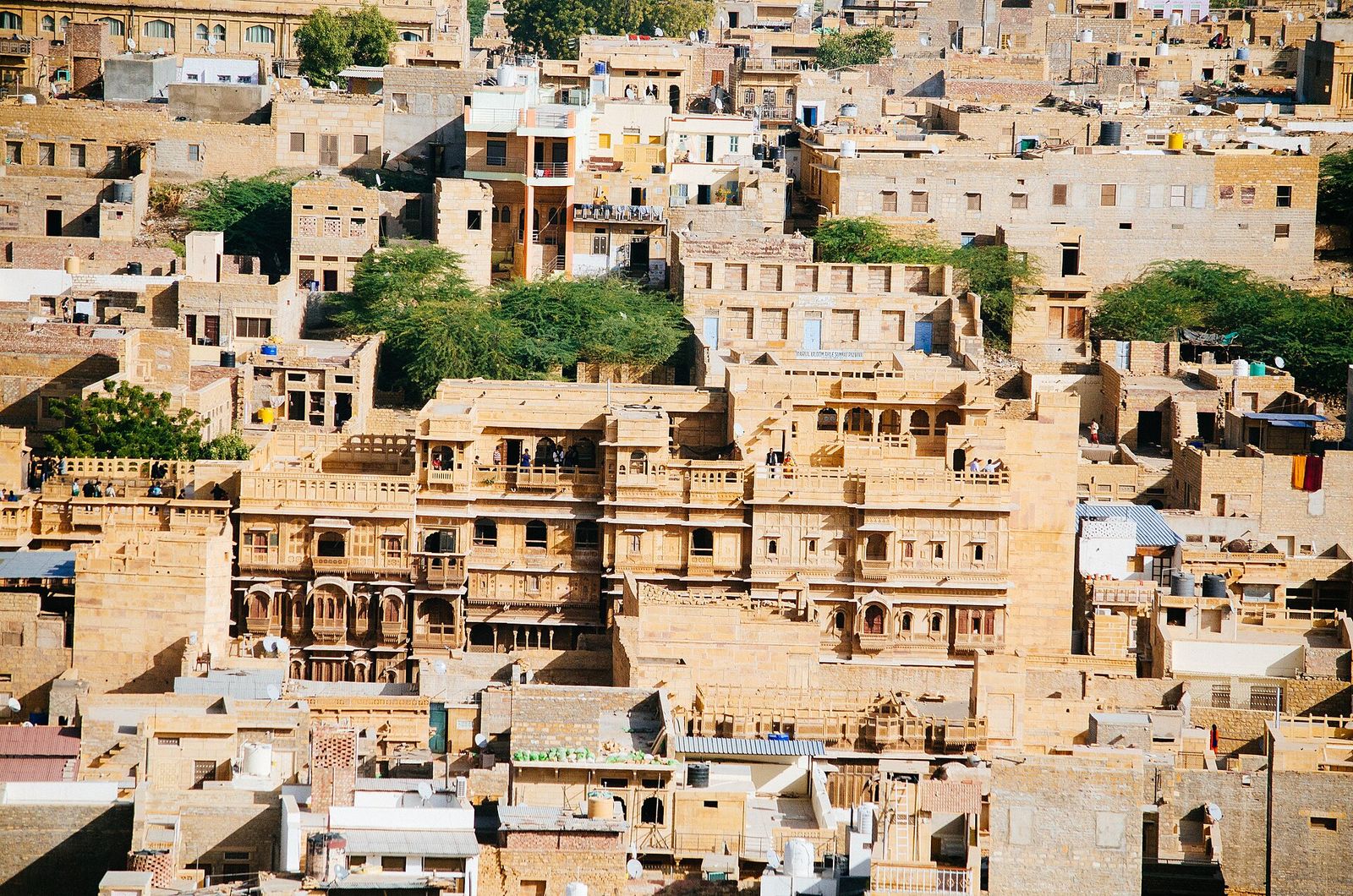 The carved sandstone facade of Patwon ki Haveli rising among the houses of Jaisalmer