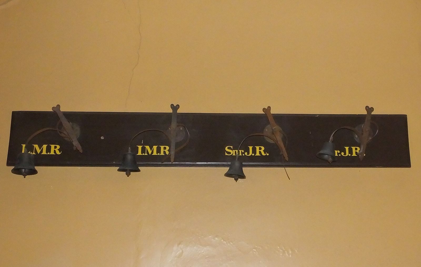 A servants' bell board at the Judges' Lodgings, Lancaster: spring bells labelled with the rooms they serve