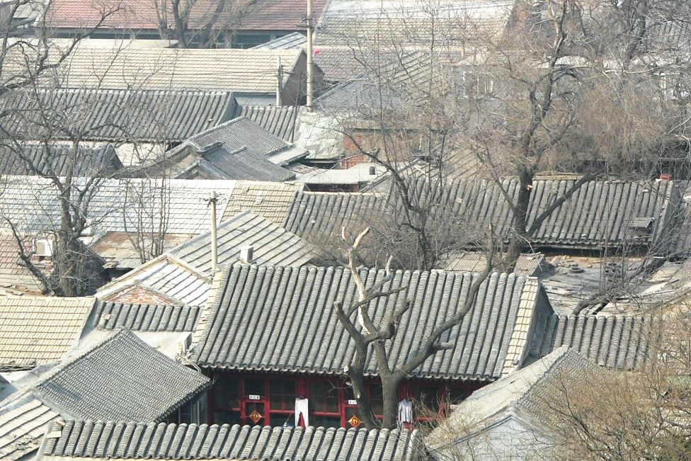 The grey-tiled roofs and courtyards of siheyuan compounds in Beijing, seen from above