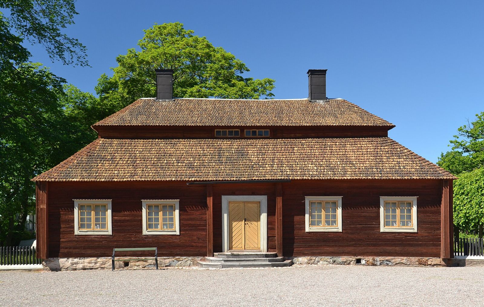 A red-painted wooden farmhouse at Skansen, Stockholm's open-air museum