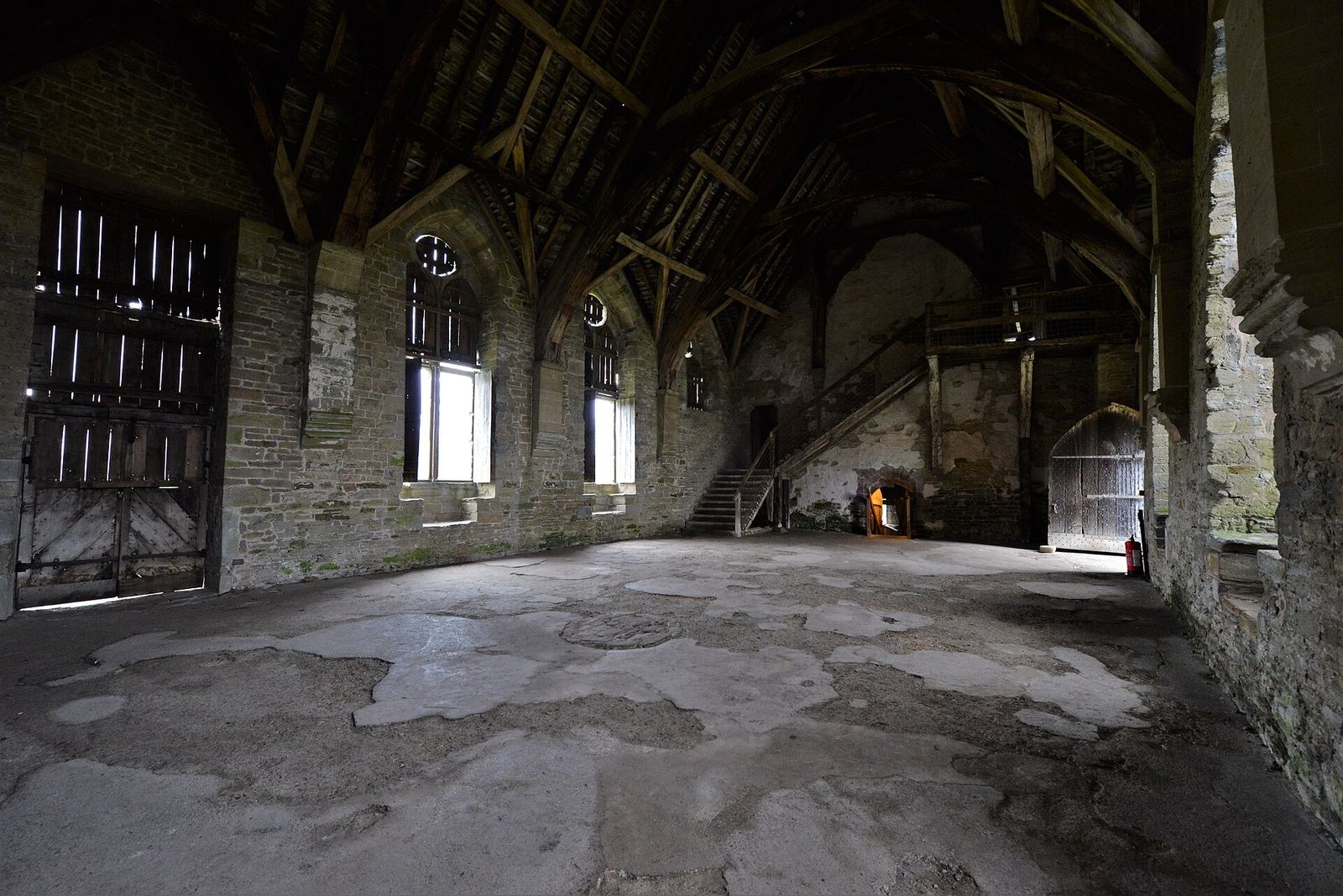 The great hall of Stokesay Castle, with its tall windows and timber roof