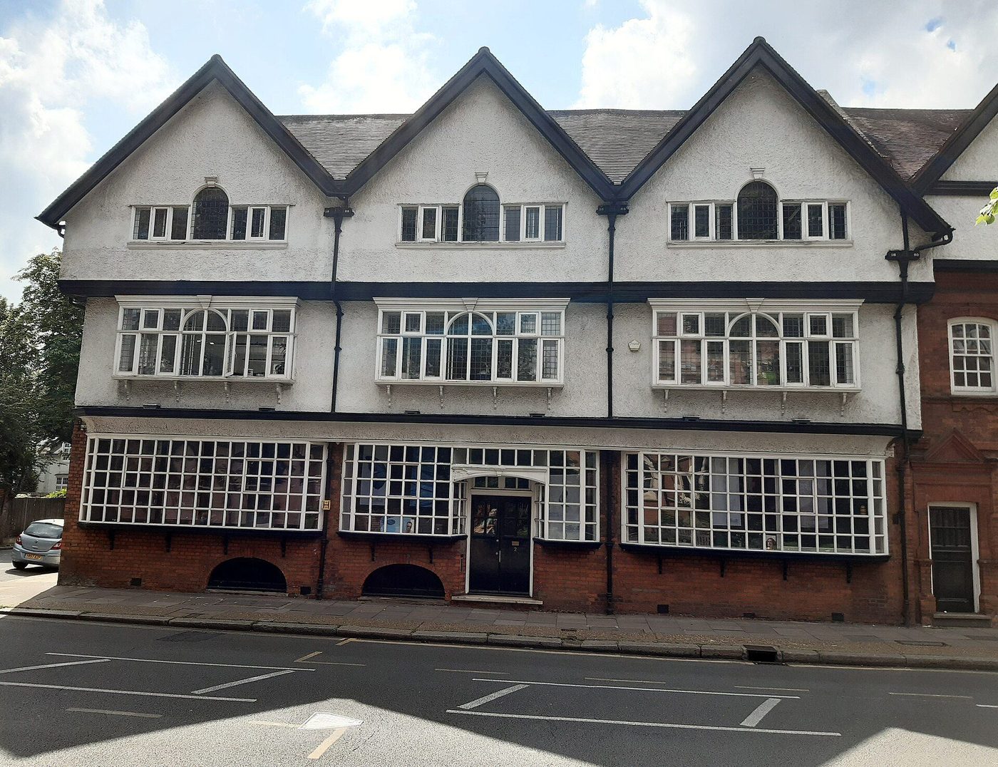 The Bedford Park Stores on Bath Road, Chiswick: gabled Queen Anne parade with shopfronts below and flats above