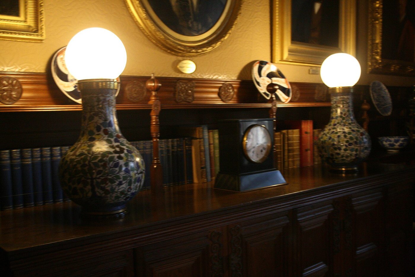 Swan's electric lamps glowing in the library at Cragside, the first house lit by hydroelectric power