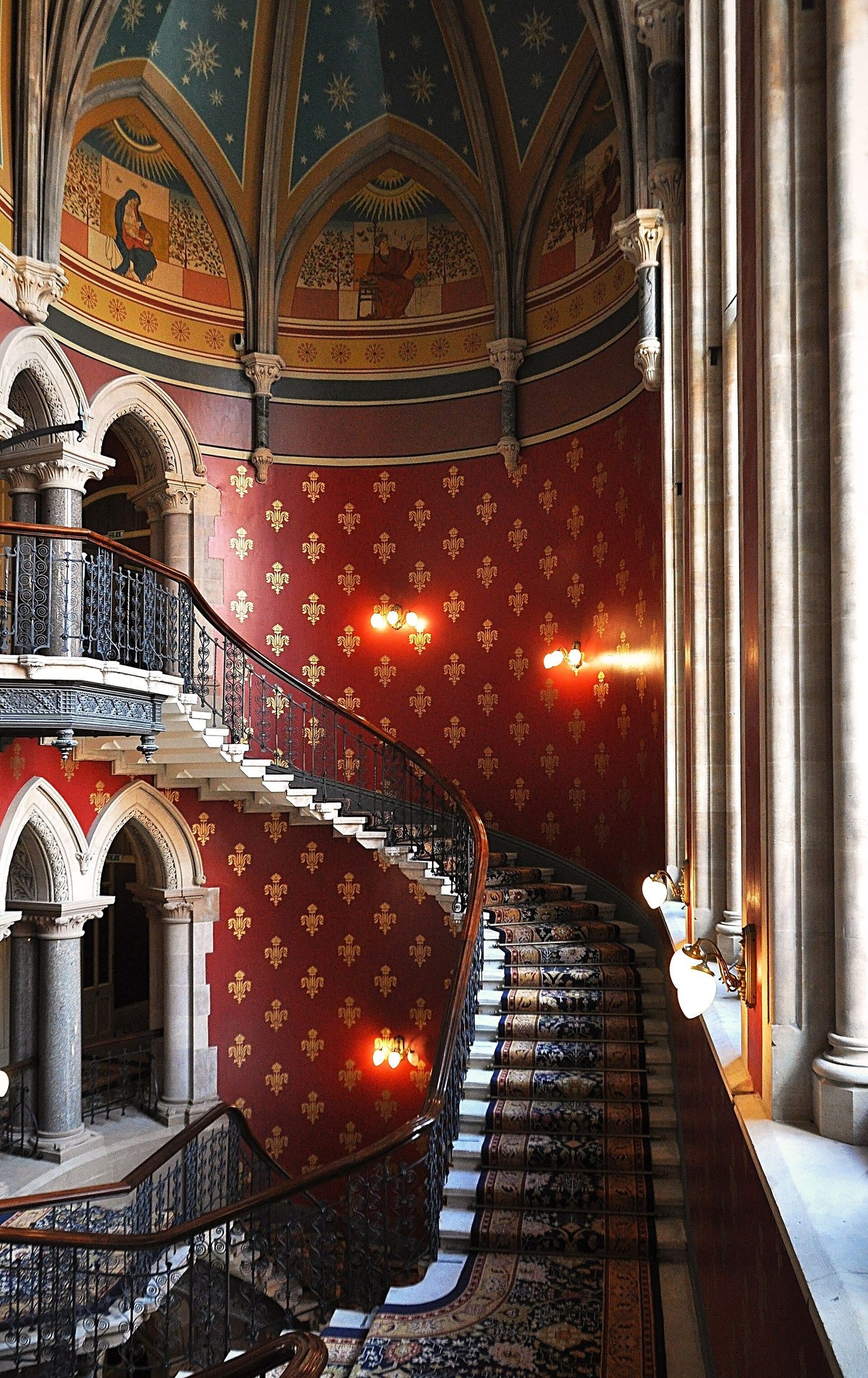 The grand staircase of the Midland Grand Hotel: the vaulted, stencilled stair hall descending in a theatrical curve