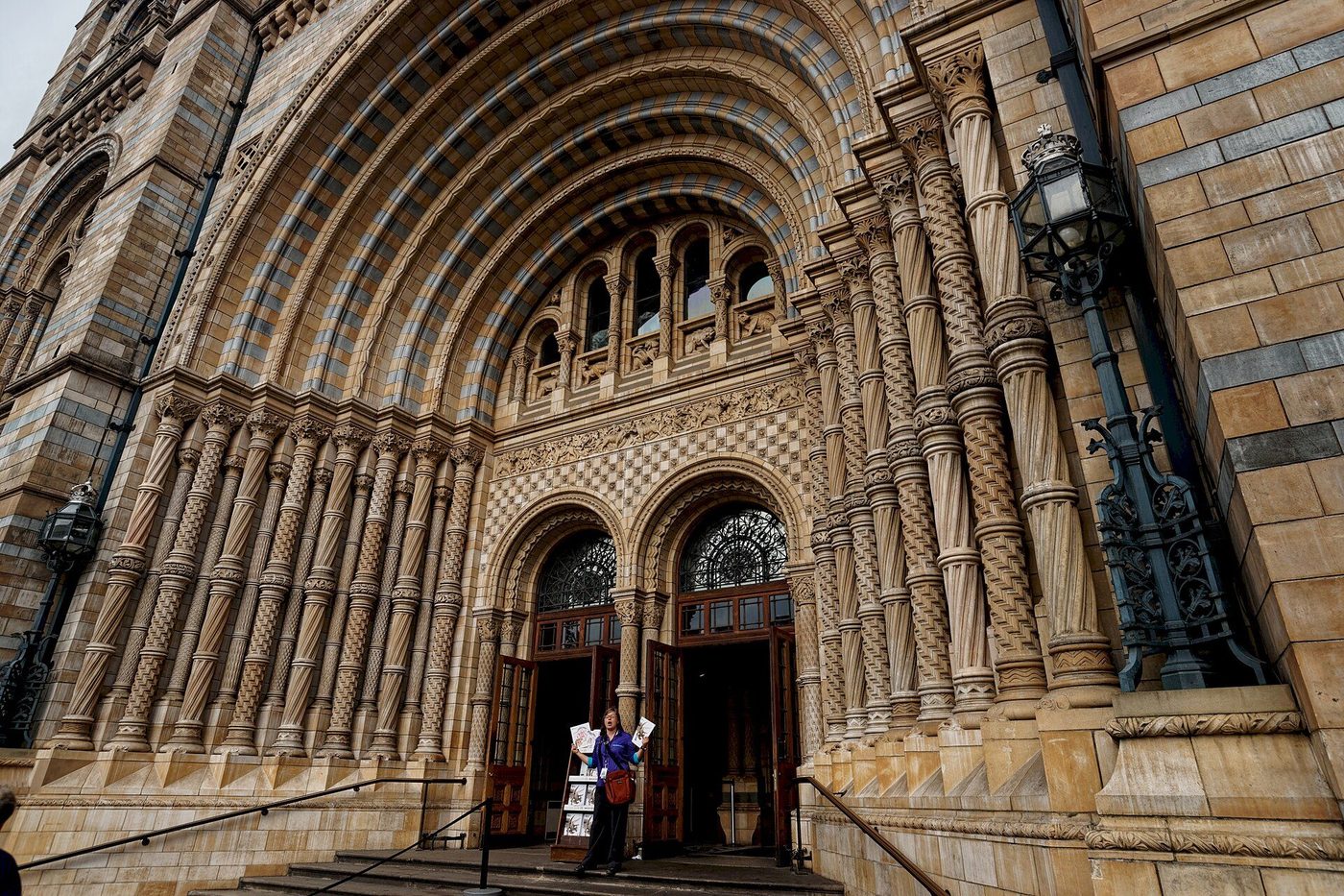The great west entrance of the Natural History Museum: concentric terracotta arches and carved stone-and-clay detail