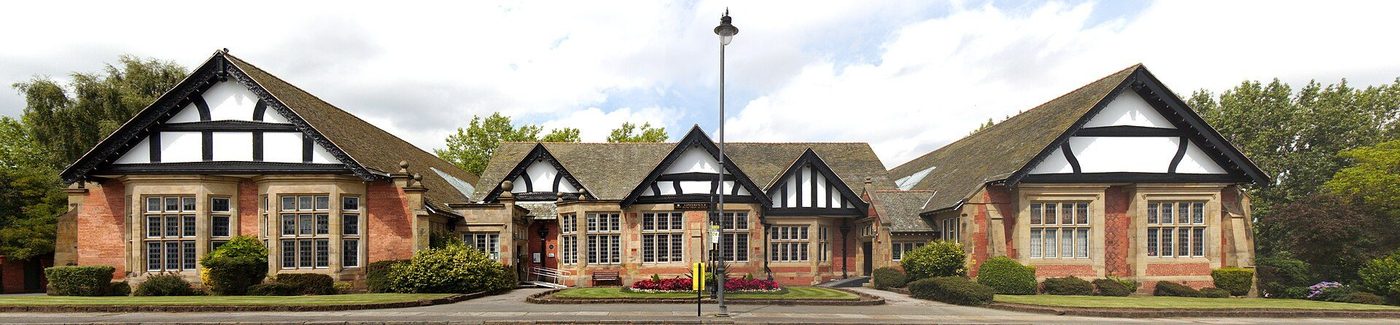 Port Sunlight: a row of the model village's brick and half-timbered cottages in their garden setting