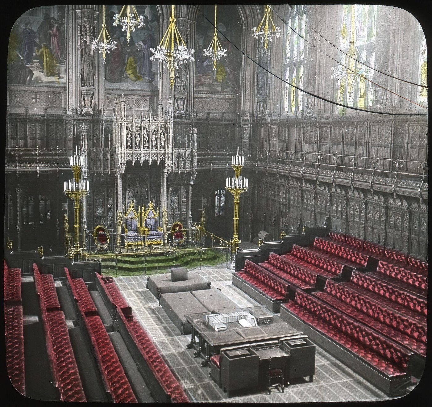 The chamber of the House of Lords in a period photochrom: the throne, the woolsack and Pugin's gilded, painted decoration