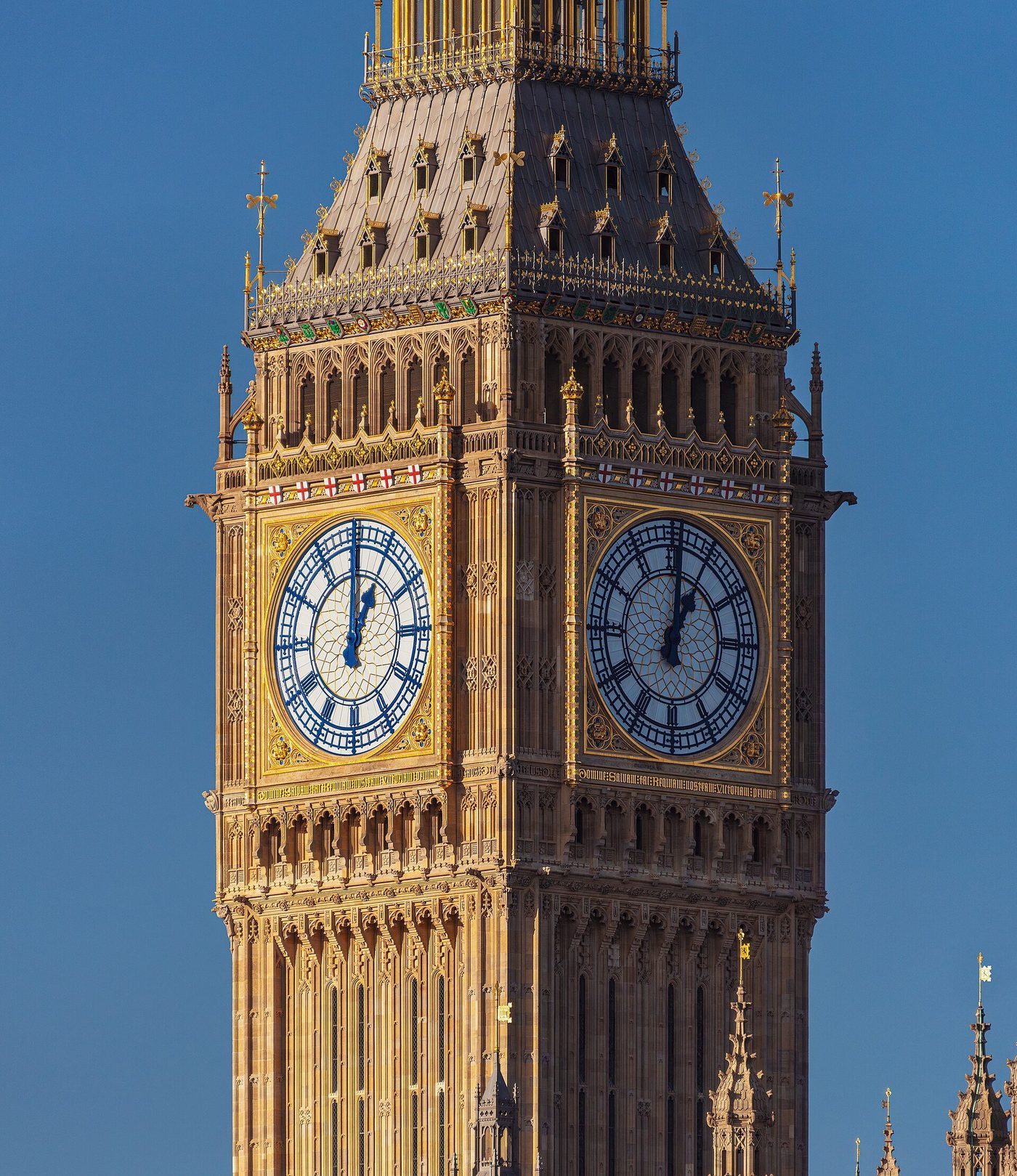 The Elizabeth Tower at Westminster close up: gilded detail, stone carving and the great clock faces