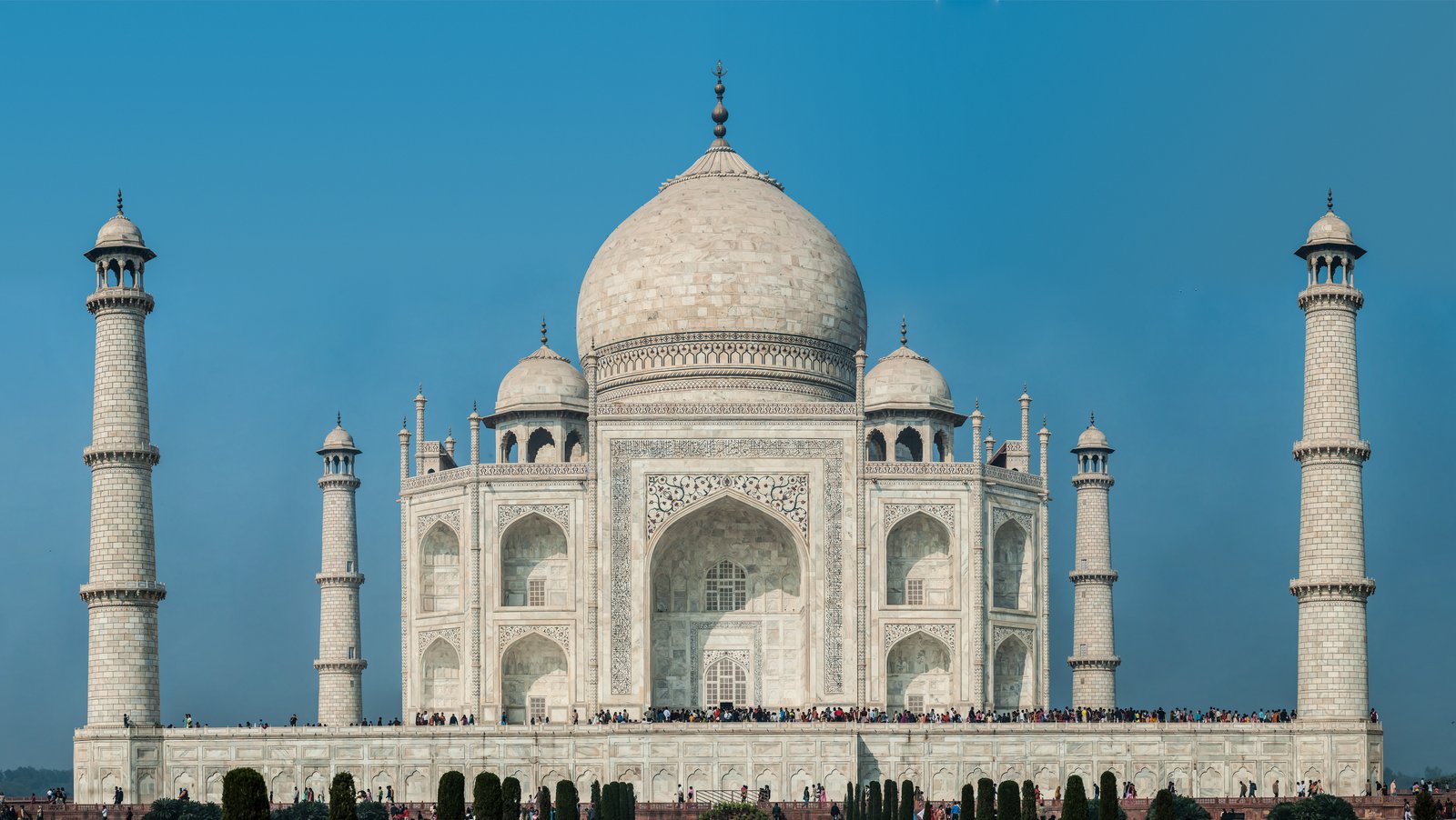 The Taj Mahal in Agra, its white marble dome and minarets at the end of its garden